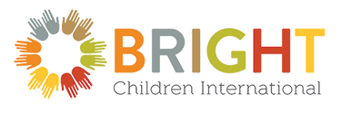 BRIGHT Children International logo. A circle of hands in different warm colors, including orange, yellow, red, green, and brown.