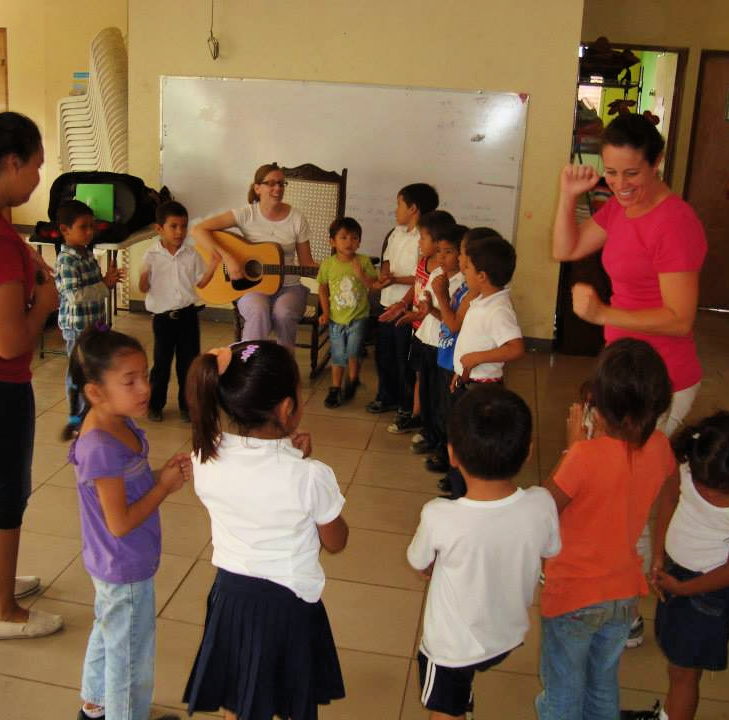 A large group of young children participating in a music therapy session along with BRIGHT Children International's music therapists.